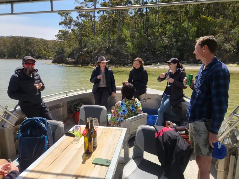 A small group of guests wading beside the oyster racks